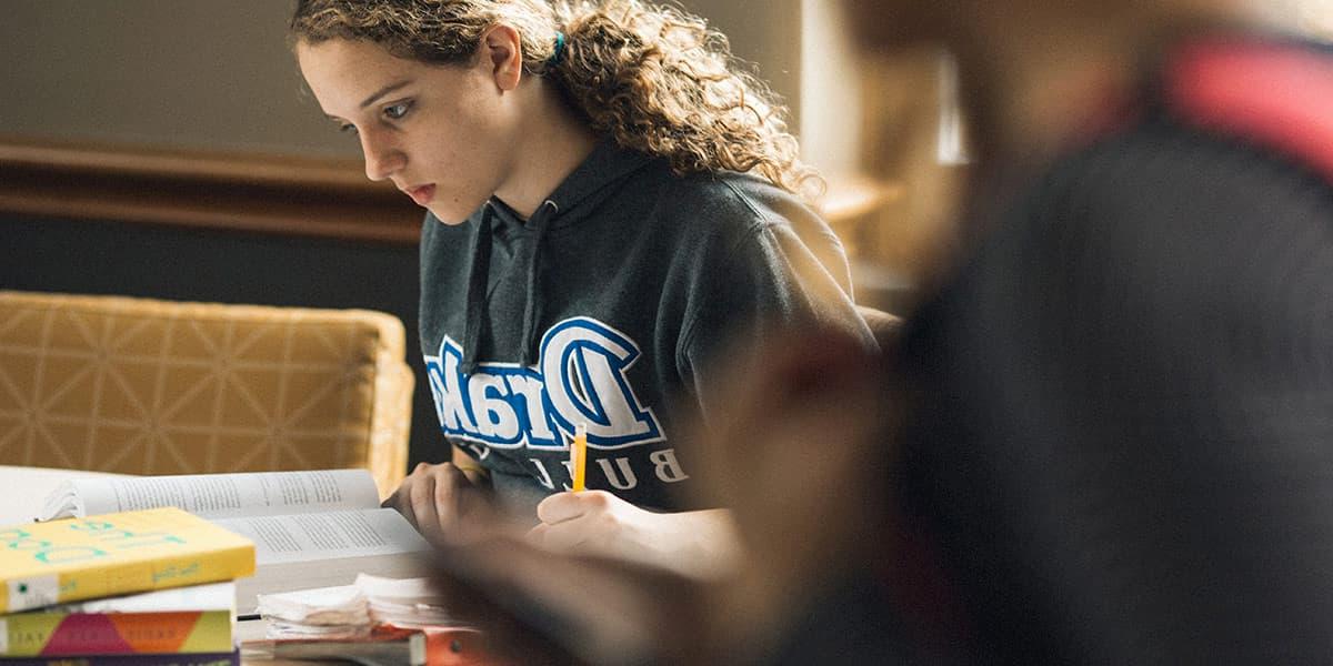 Drake University student studying in the library 